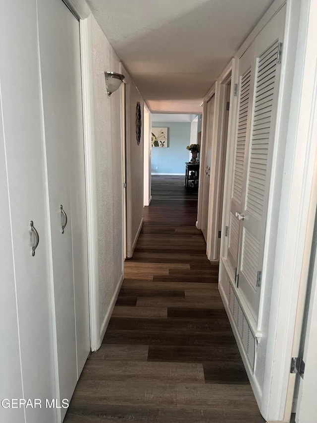 hallway with dark hardwood / wood-style flooring