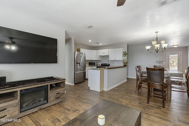 living room with a chandelier and dark hardwood / wood-style floors