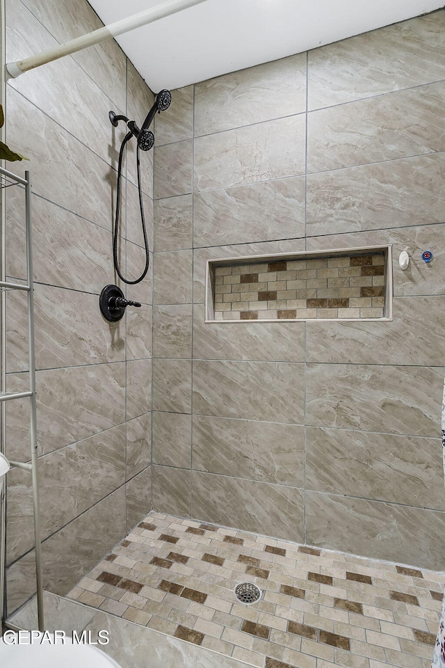 bathroom with a tile shower