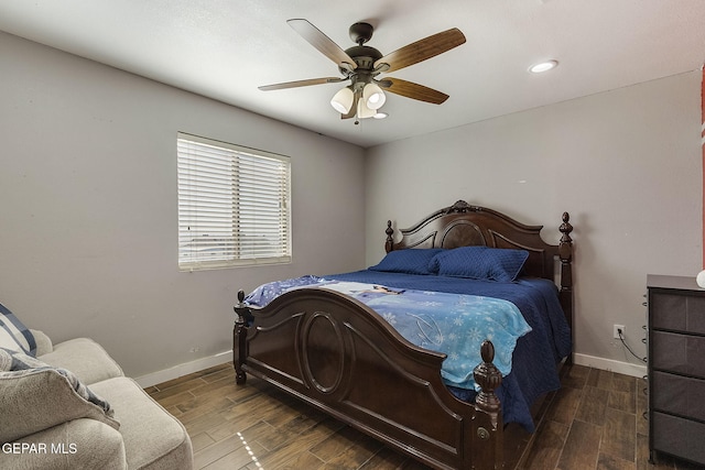 bedroom with ceiling fan and dark wood-type flooring