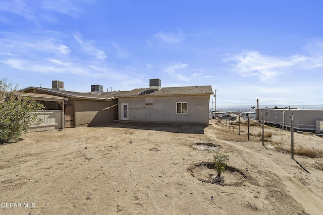 rear view of property featuring central AC unit