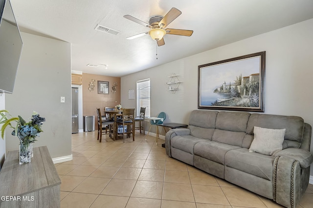 tiled living room with ceiling fan