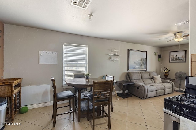 tiled dining area with ceiling fan