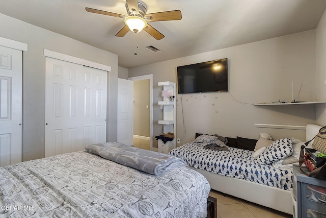 bedroom with ceiling fan and light tile patterned flooring