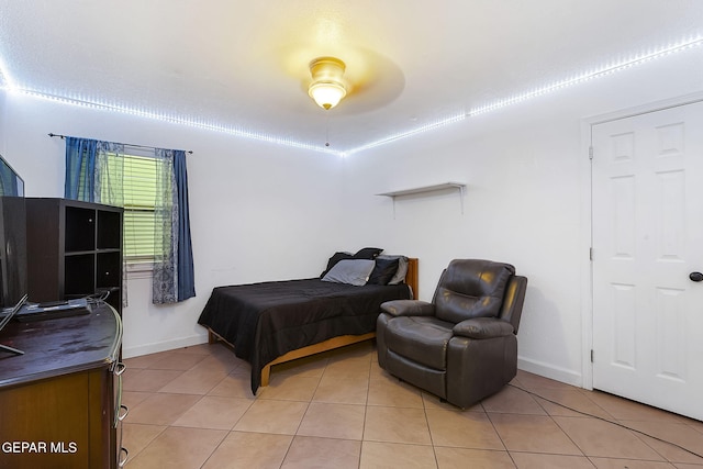 bedroom featuring ceiling fan and light tile patterned floors