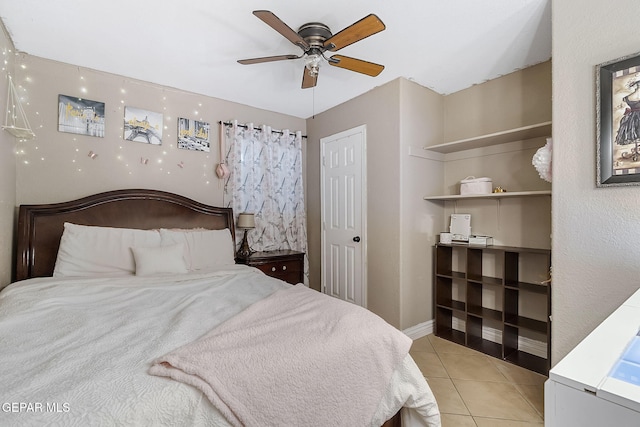 bedroom with ceiling fan and light tile patterned floors