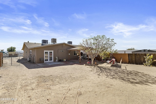 rear view of property featuring french doors, a patio, and central air condition unit