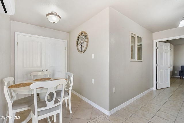 tiled dining area featuring an AC wall unit