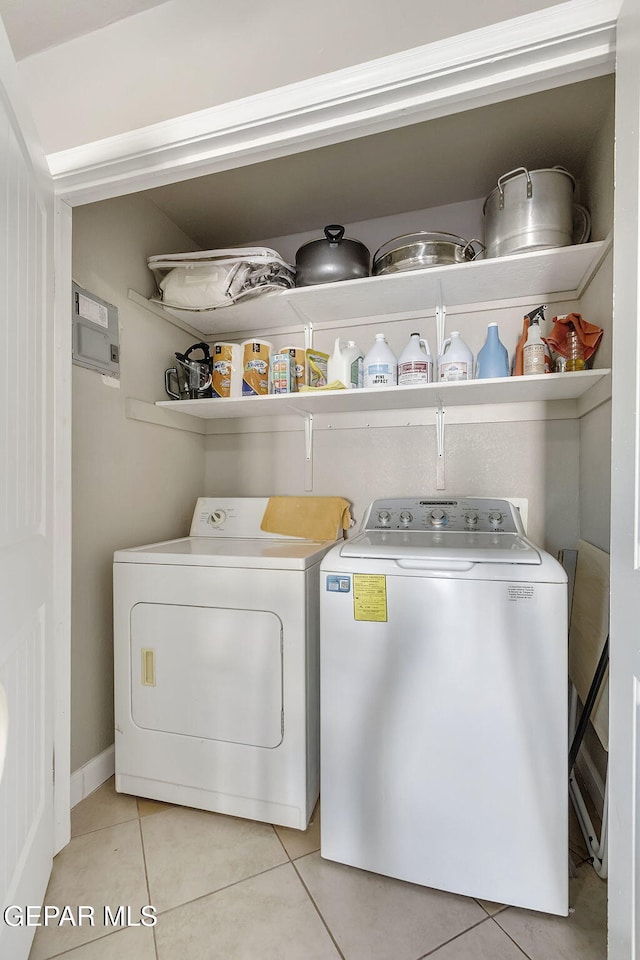 laundry room with light tile patterned floors and independent washer and dryer