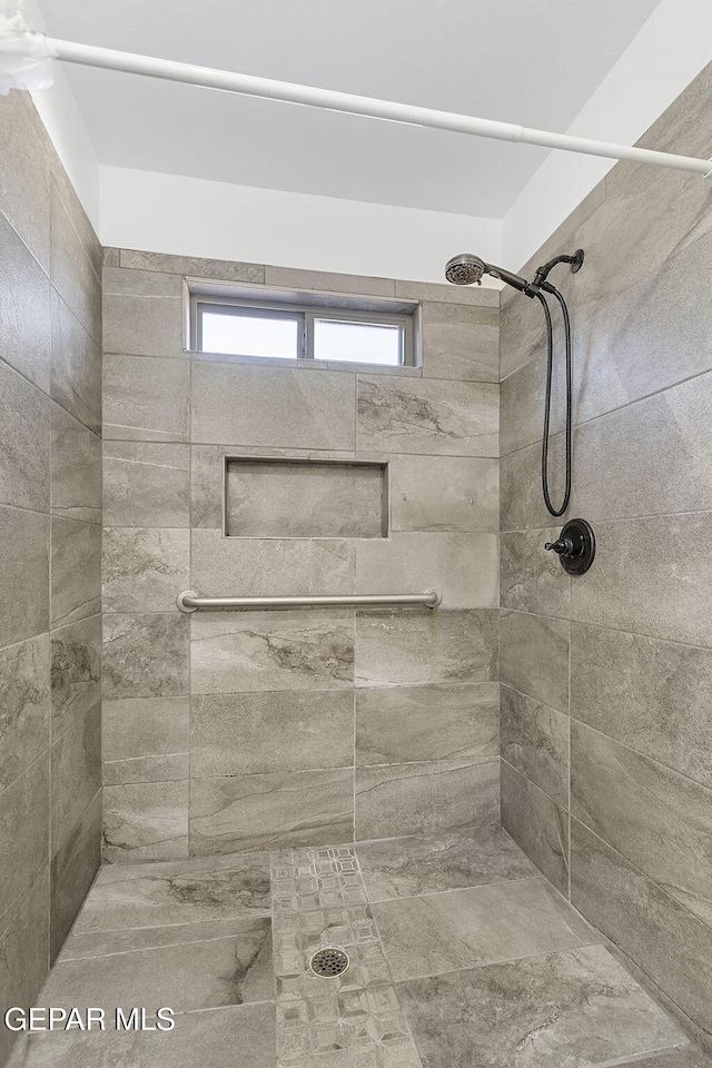 bathroom with tiled shower