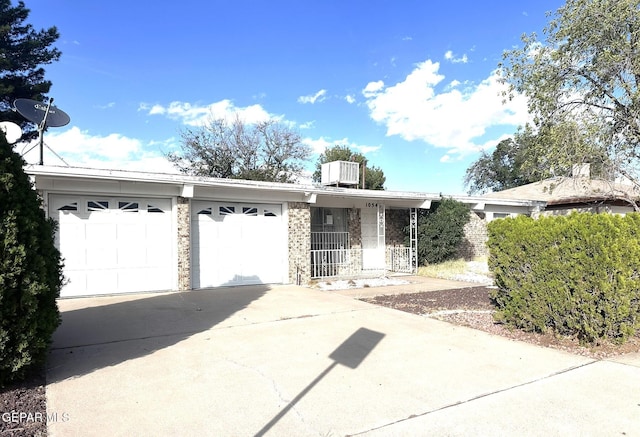 10545 Springwood Dr, El Paso, TX 79925 - single story home with concrete driveway, an attached garage, and stone siding
