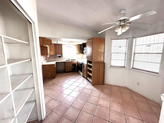 10545 Springwood Dr, El Paso, TX 79925 - kitchen with light countertops, plenty of natural light, a ceiling fan, and a sink