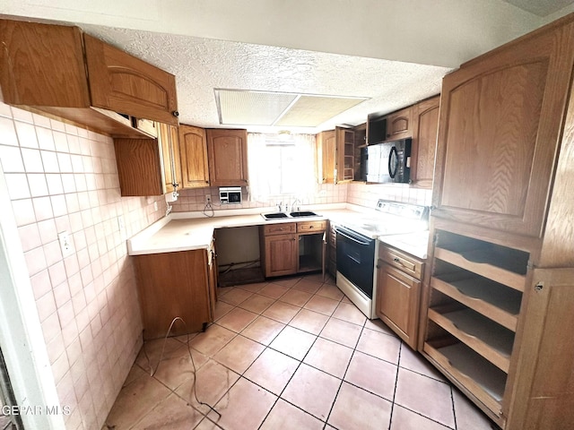 kitchen with light tile patterned floors, backsplash, white range with electric cooktop, and sink