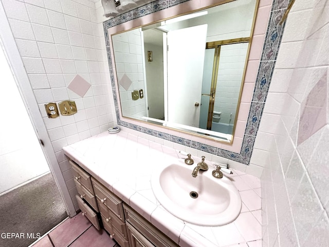 10545 Springwood Dr, El Paso, TX 79925 - bathroom with vanity, tile walls, and tile patterned flooring