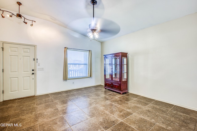 foyer entrance with ceiling fan and lofted ceiling