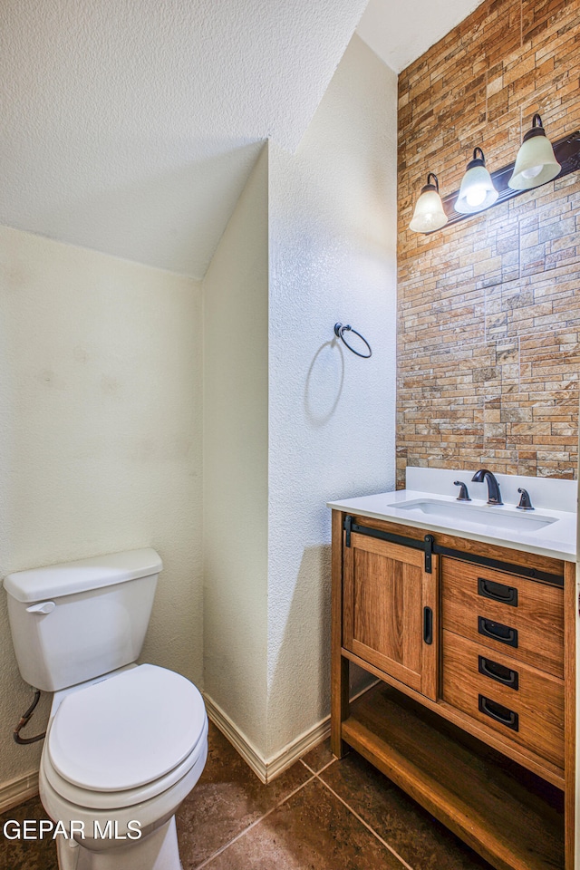 bathroom with tile patterned flooring, vanity, and toilet