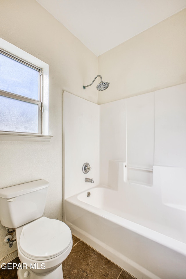 bathroom featuring tile patterned flooring, shower / bath combination, and toilet