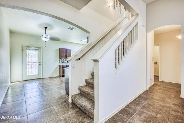 entryway with tile patterned floors and ceiling fan