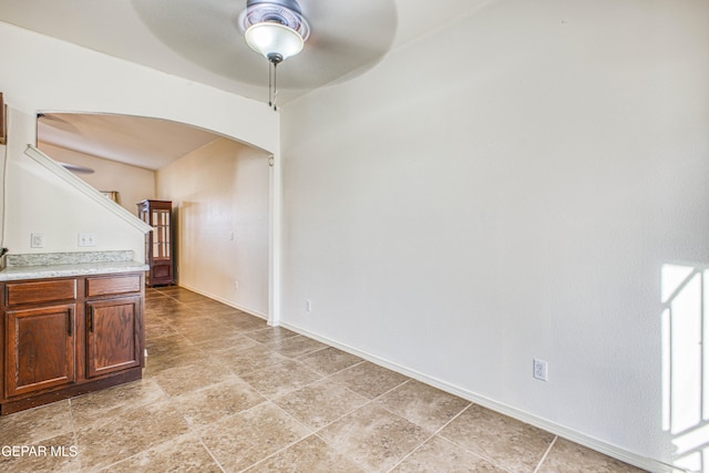 interior space with ceiling fan and light tile patterned flooring