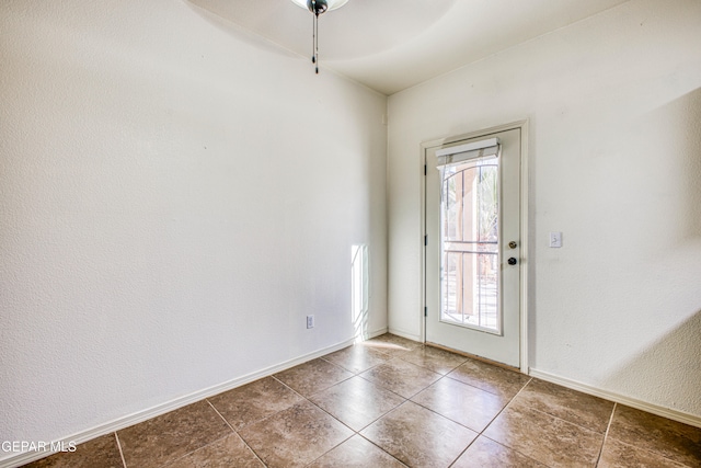 entryway with tile patterned flooring and ceiling fan