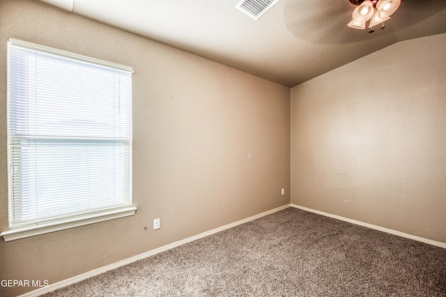 empty room featuring carpet floors, a wealth of natural light, ceiling fan, and lofted ceiling