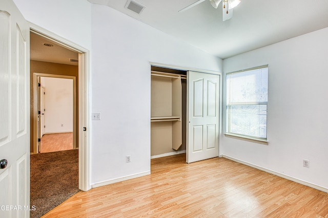 unfurnished bedroom with ceiling fan, lofted ceiling, and light hardwood / wood-style flooring