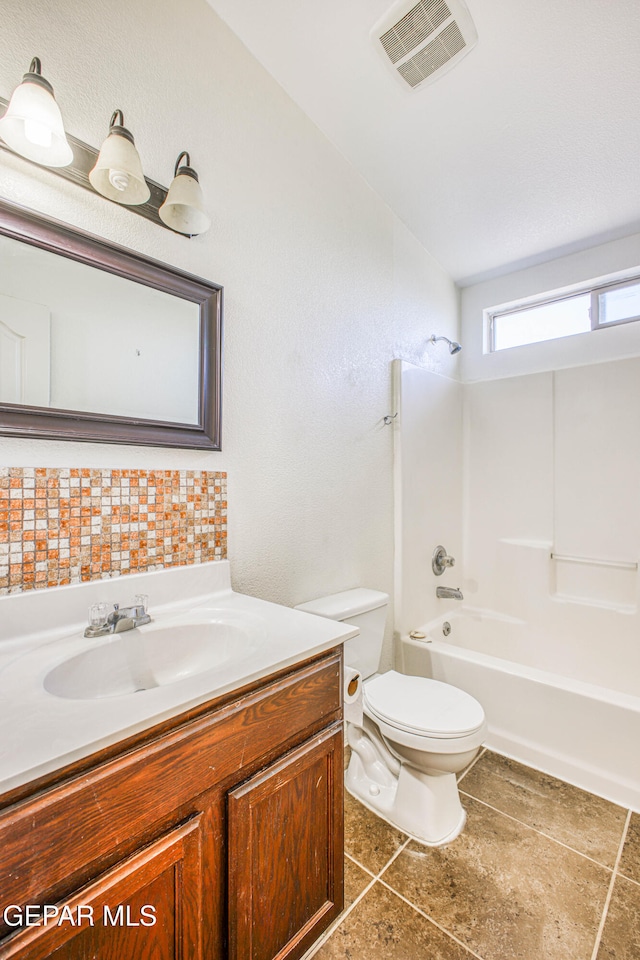 full bathroom featuring tile patterned floors, vaulted ceiling, toilet, shower / tub combination, and vanity