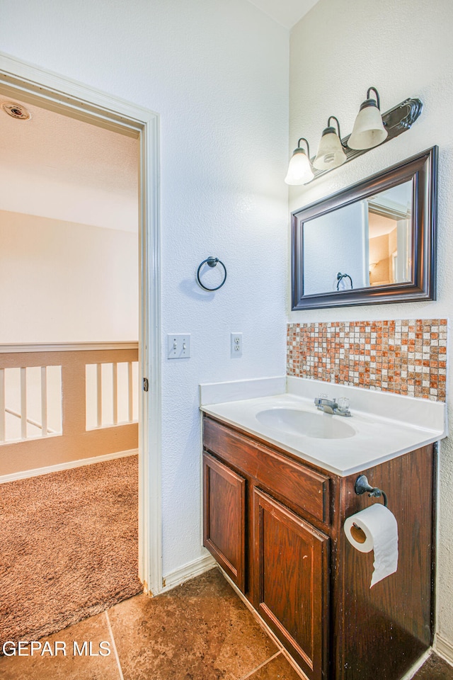 bathroom with vanity, tasteful backsplash, and tile patterned floors