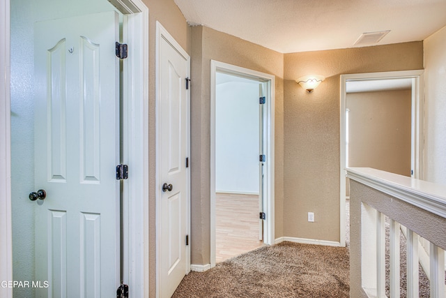 corridor with light colored carpet