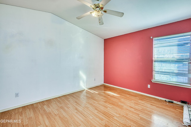 unfurnished room with light hardwood / wood-style floors, ceiling fan, and lofted ceiling