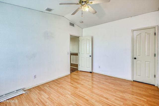 spare room featuring ceiling fan, lofted ceiling, and light hardwood / wood-style flooring