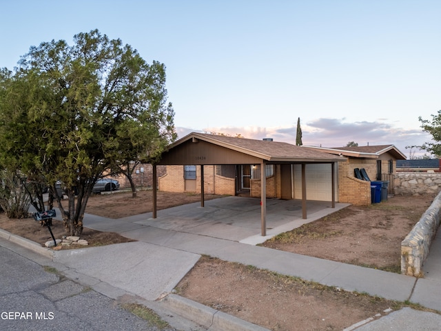 ranch-style house with a carport and a garage