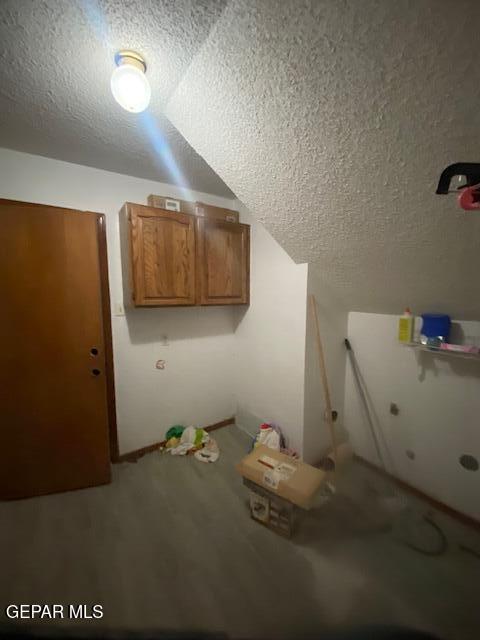 laundry area with a textured ceiling