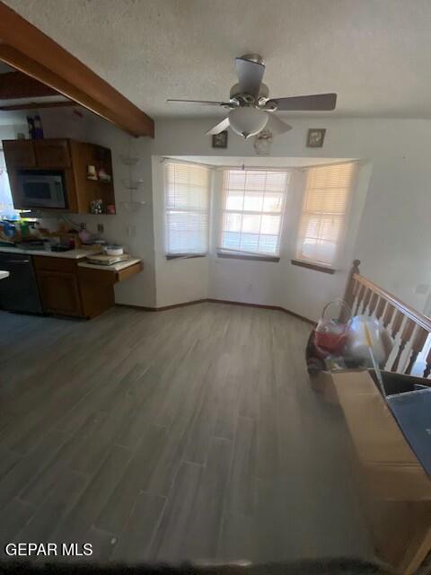 unfurnished living room with hardwood / wood-style floors, a textured ceiling, and ceiling fan