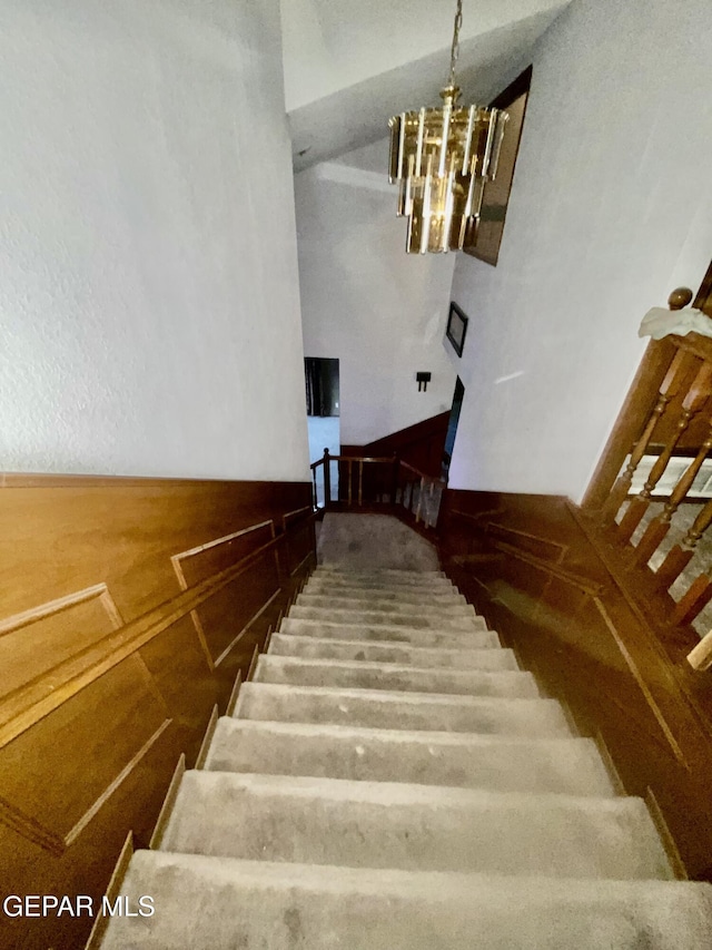 stairway with an inviting chandelier