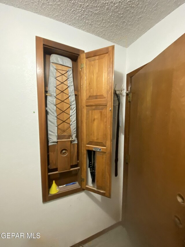 utility room with a textured ceiling