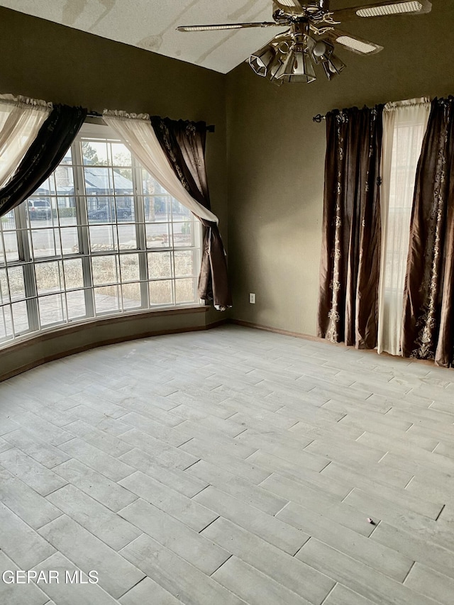 unfurnished room featuring light hardwood / wood-style flooring and ceiling fan