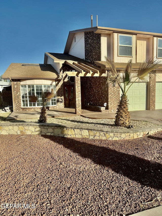 rear view of house featuring a garage