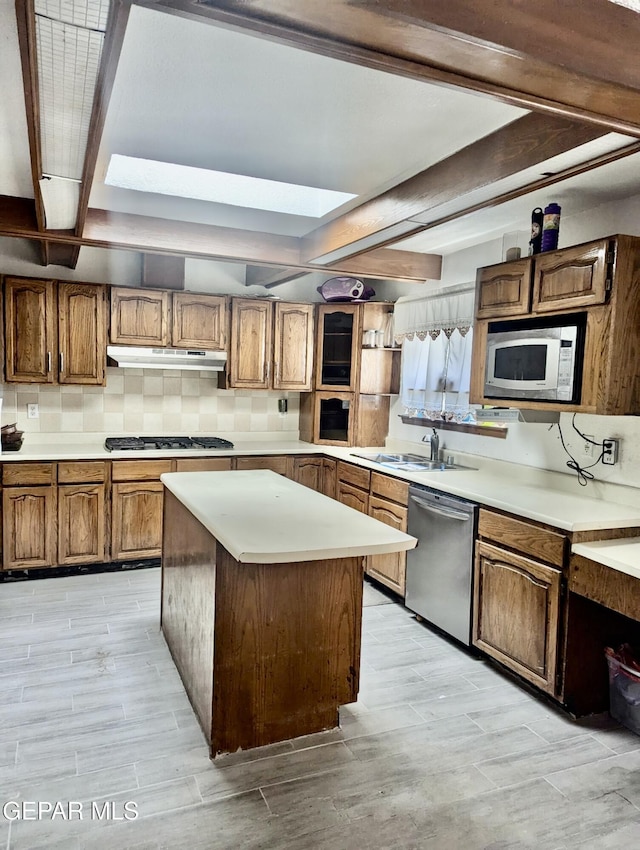 2078 Gus Moran St, El Paso, TX 79936 - kitchen with stainless steel appliances, beam ceiling, light countertops, tasteful backsplash, and brown cabinets