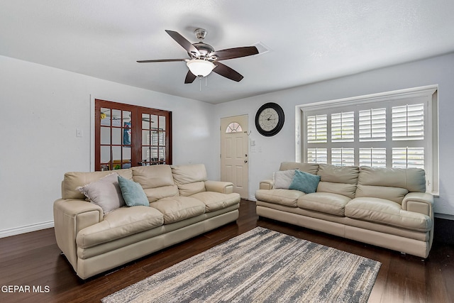 living room featuring ceiling fan and dark hardwood / wood-style floors