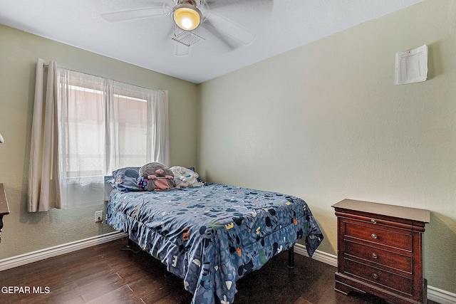 bedroom featuring dark hardwood / wood-style flooring and ceiling fan