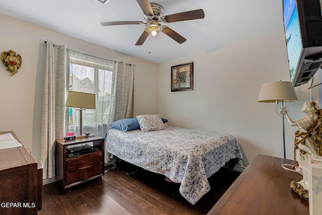 bedroom featuring ceiling fan and dark wood-type flooring