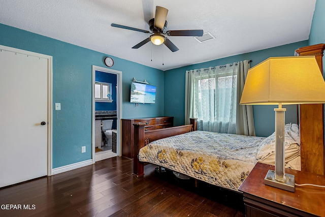 bedroom with a textured ceiling, dark hardwood / wood-style floors, ensuite bath, and ceiling fan