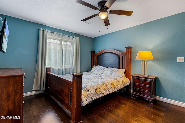 bedroom with ceiling fan and dark wood-type flooring