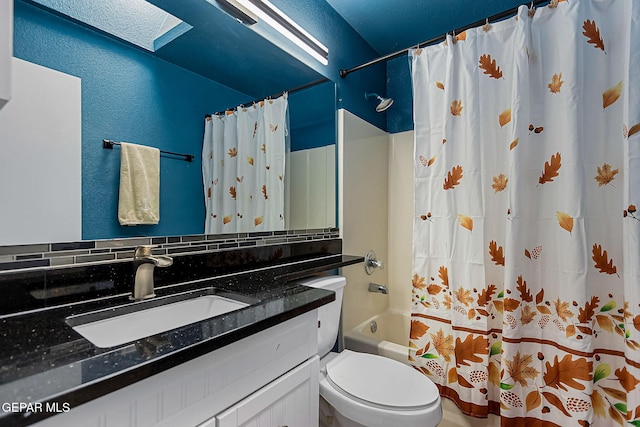 full bathroom with vanity, a skylight, toilet, and shower / bathtub combination with curtain