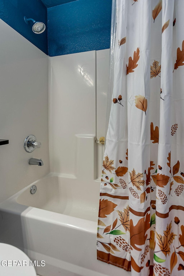 bathroom with shower / bathtub combination with curtain