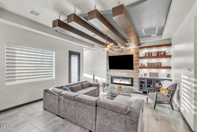 living room featuring a fireplace, beam ceiling, light tile patterned floors, and ceiling fan