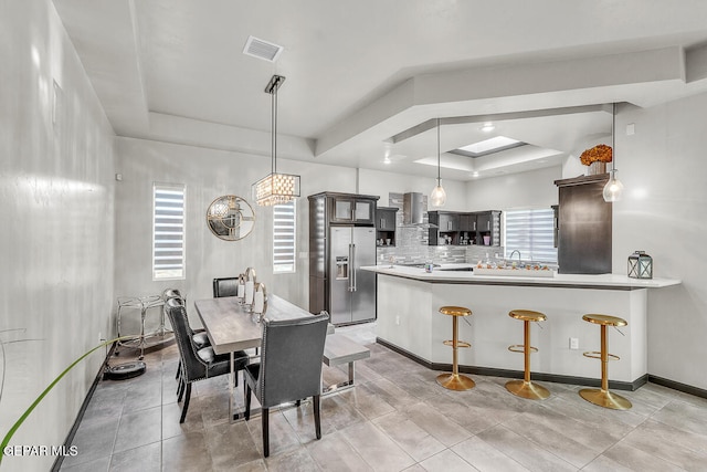 dining room featuring a raised ceiling