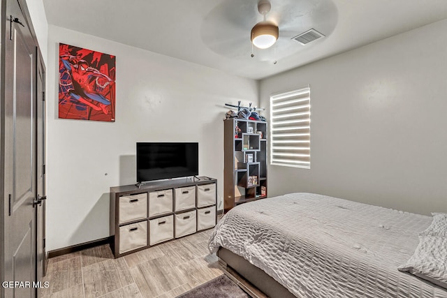 bedroom with ceiling fan and light hardwood / wood-style floors