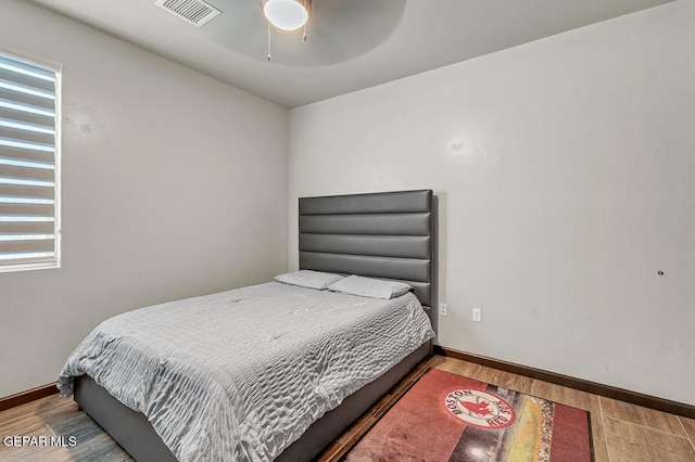 bedroom with wood-type flooring and ceiling fan